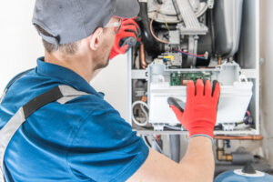 Technician Trying To Fix the Problem with Residential Heating Equipment.