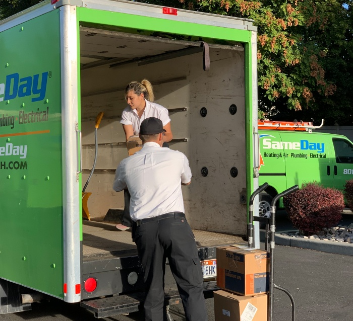 People unloading a service vehicle.
